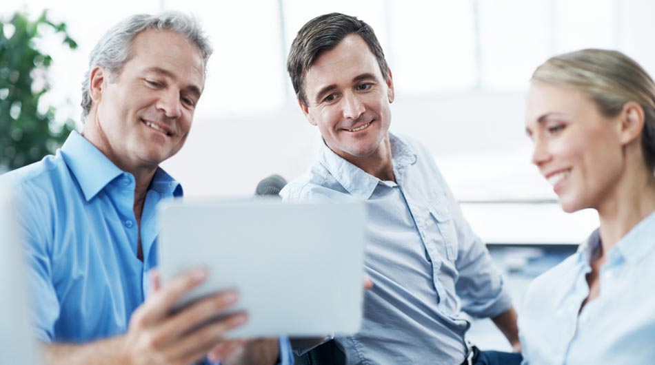 businessman using a tablet to show new website to his colleagues